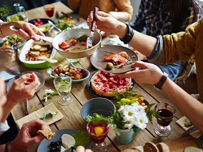 An extended family eating lunch in a dining room