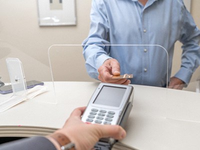 A patient using a credit card to pay for their dental care