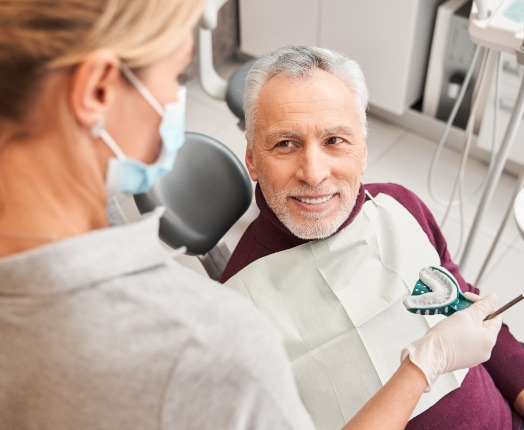 An older man receiving dental impressions for dentures