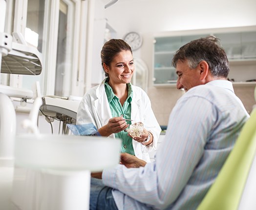 A man consulting his dentist about teeth whitening treatment